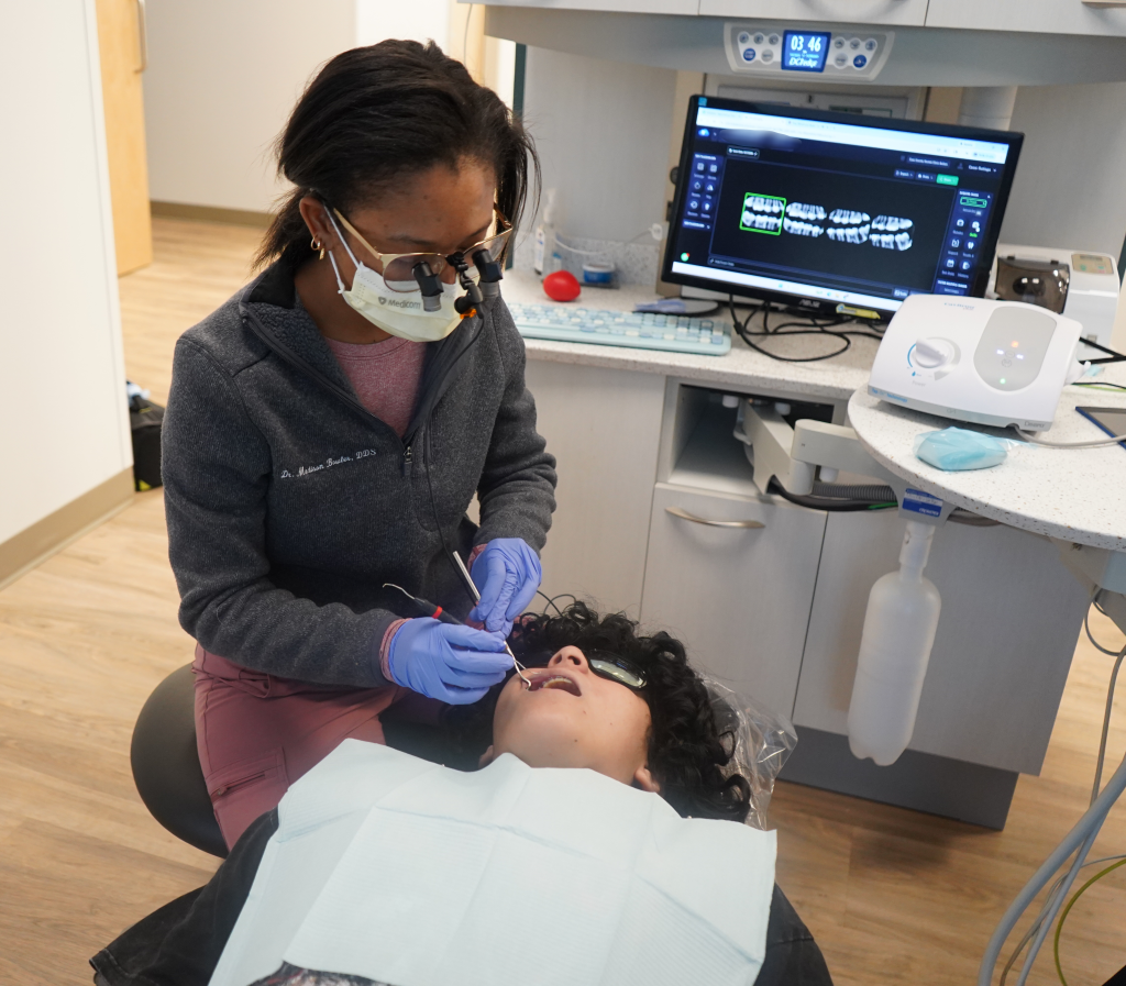 Image of dental hygienist treating child patient at United Way Impact 100 partner Cass County Dental Clinic