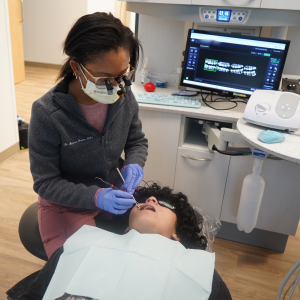 Image of dental hygienist treating child patient at United Way Impact 100 partner Cass County Dental Clinic