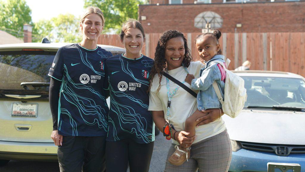 Image of Karly, her daughter, and two KC Current players volunteering for United Way Seasons of Giving: Spring Edition at Sheffield Place